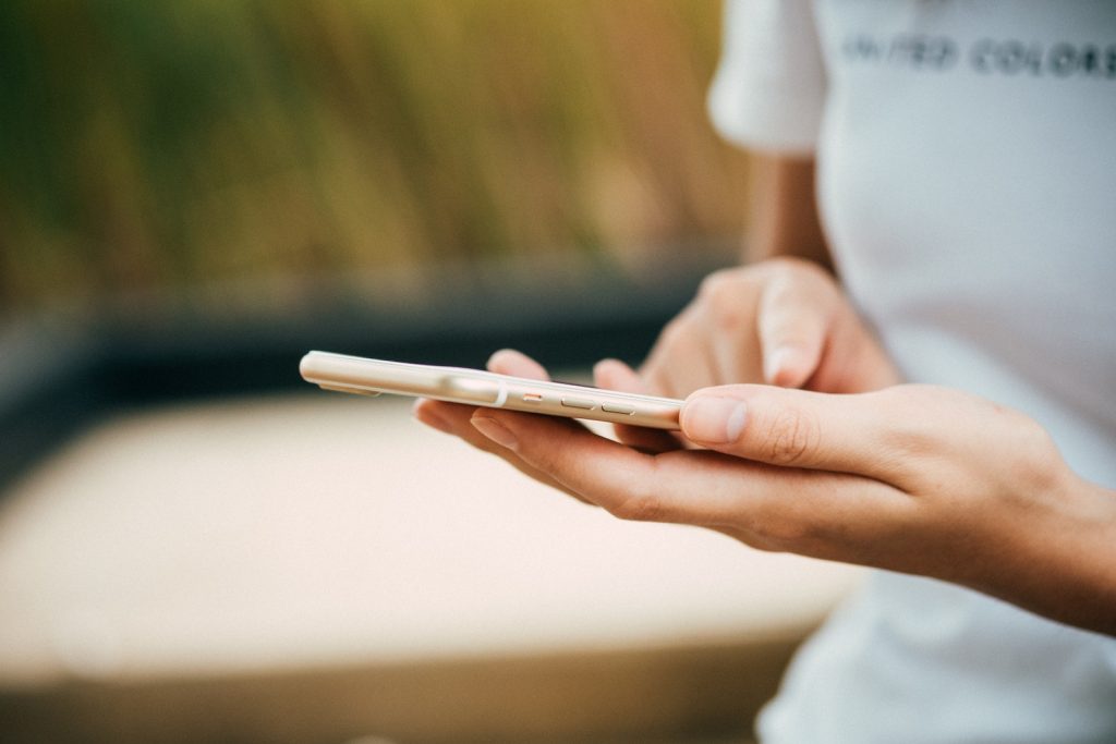 Person Standing While Using Phone to check a security update