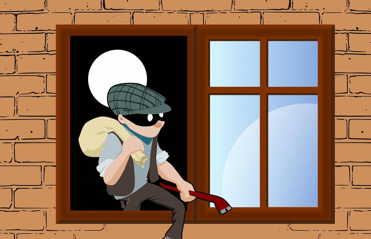 image of burglar coming out of window