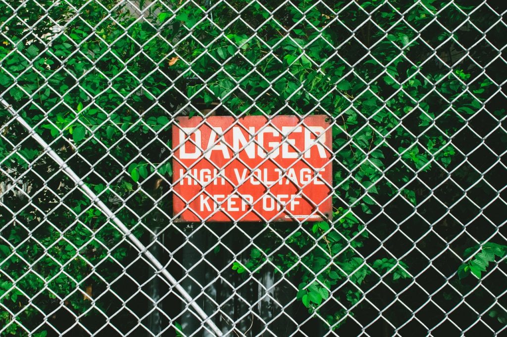 text of danger high voltage keep off in fence