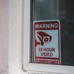 Signboard video surveillance placed on window in daytime