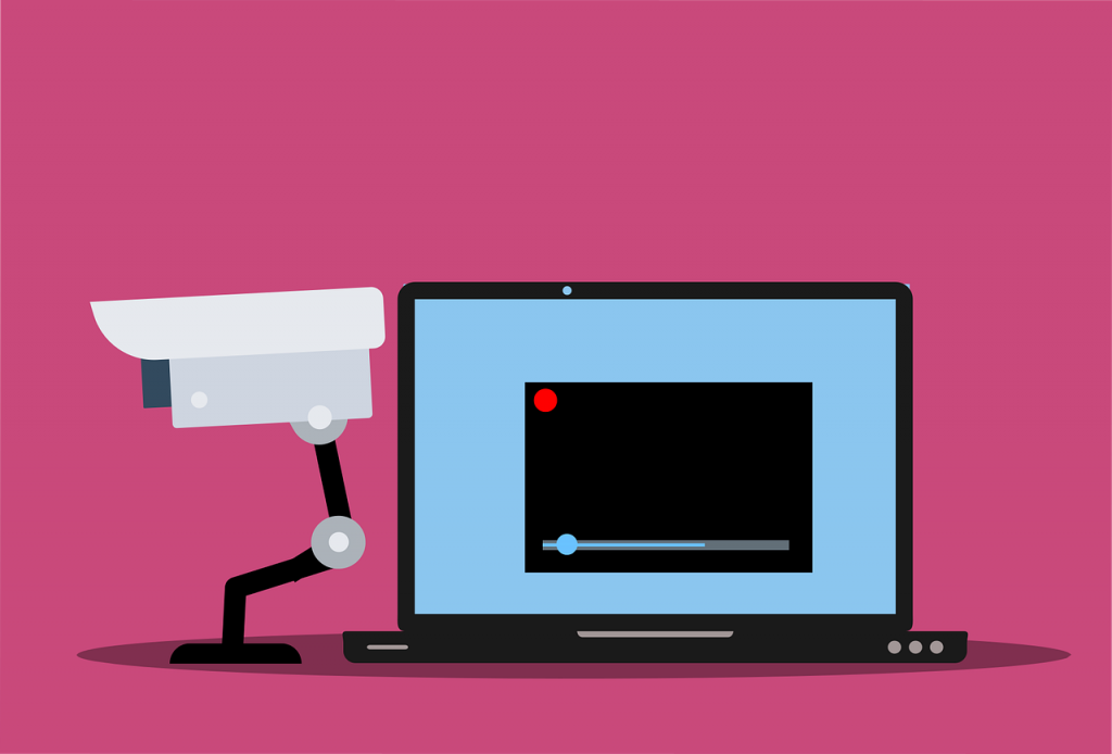cctv and laptop on pink background