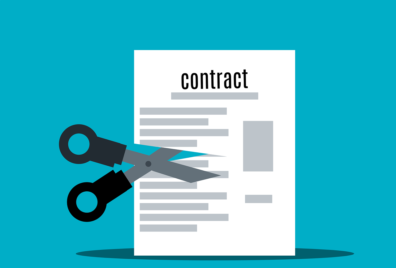 photo of contract and scissors on blue background