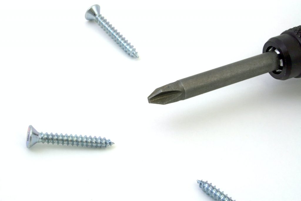 Gray Screw Near Screw Driver