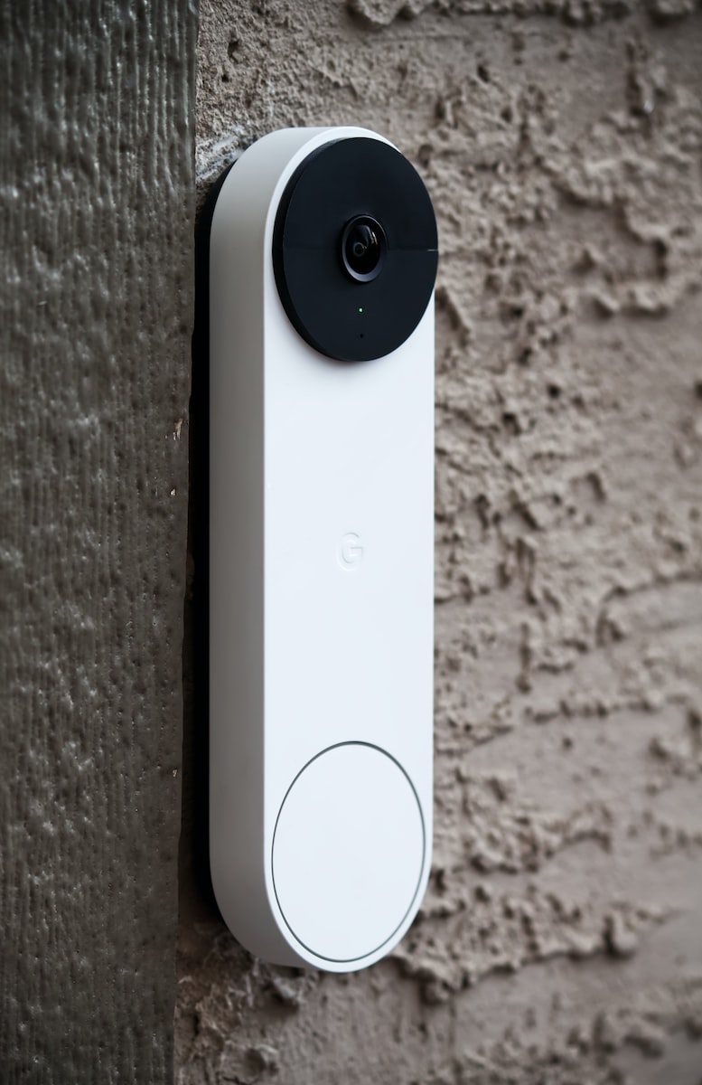 smart doorbell with white body and black camera