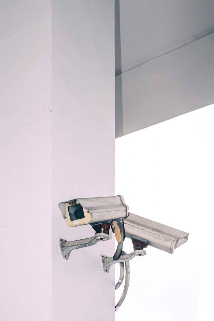 two bullet security camera attached on wall